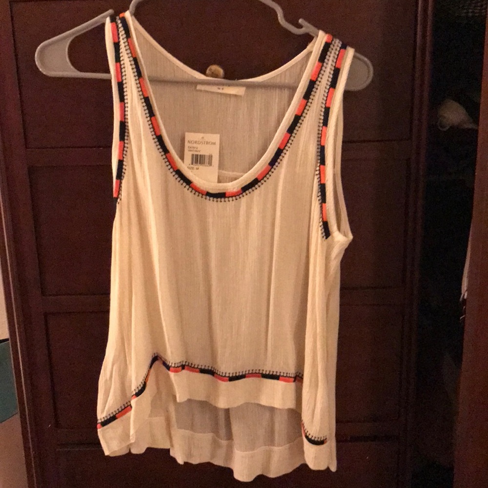 White top with navy and orange detailing